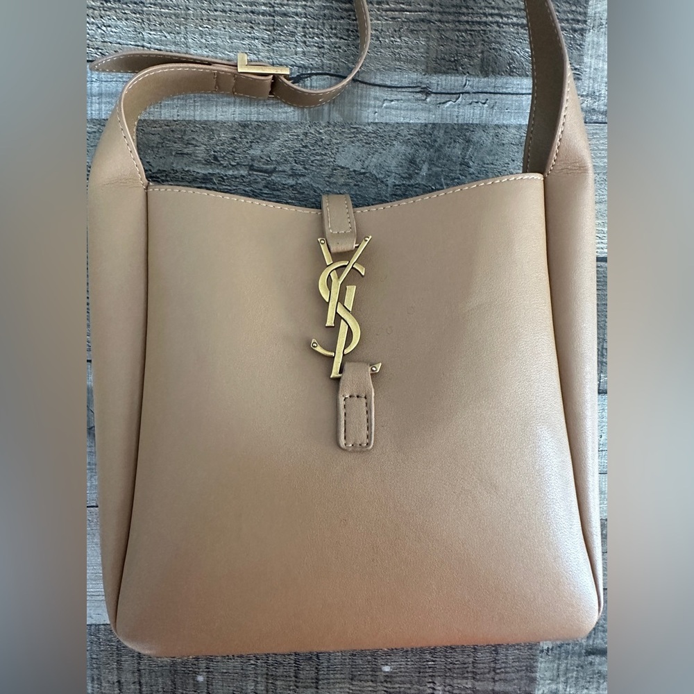Tan shoulder bag with gold hardware.
